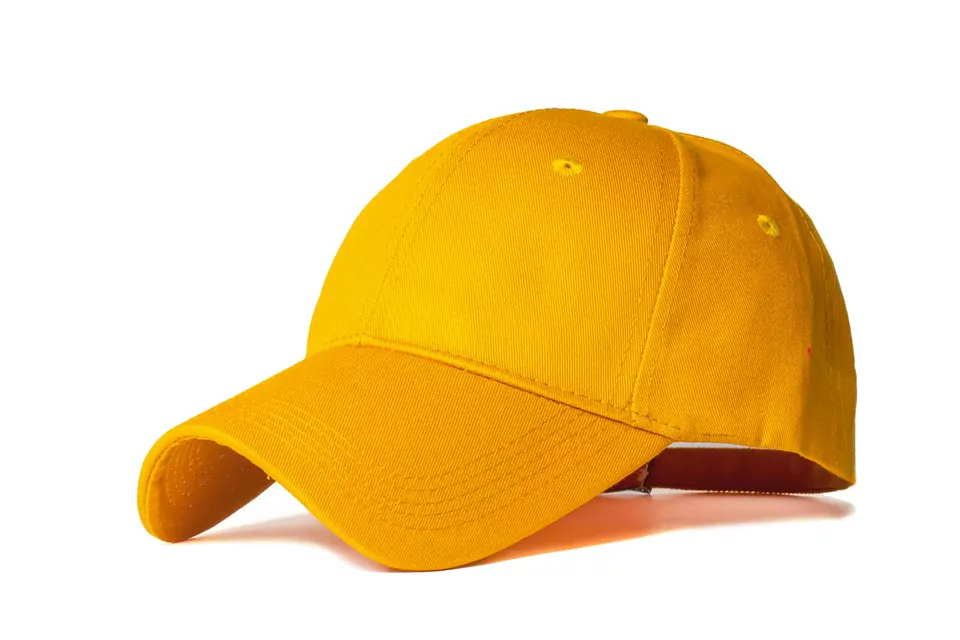 A plain yellow baseball cap on a white background