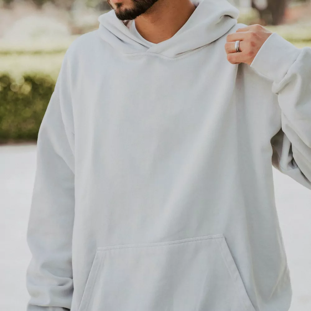 A pale grey pullover hoodie, worn