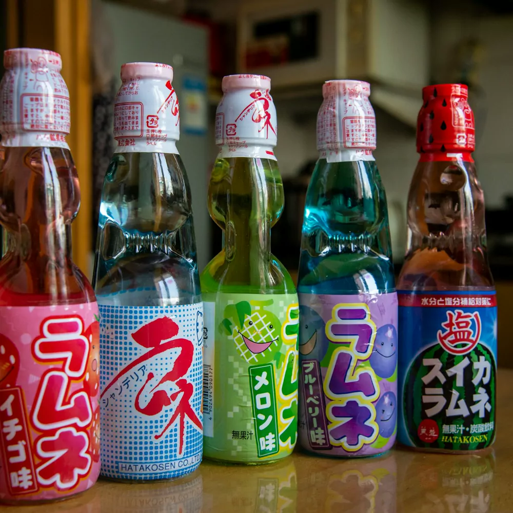 A row of Japanese Ramune glass bottles in different flavours