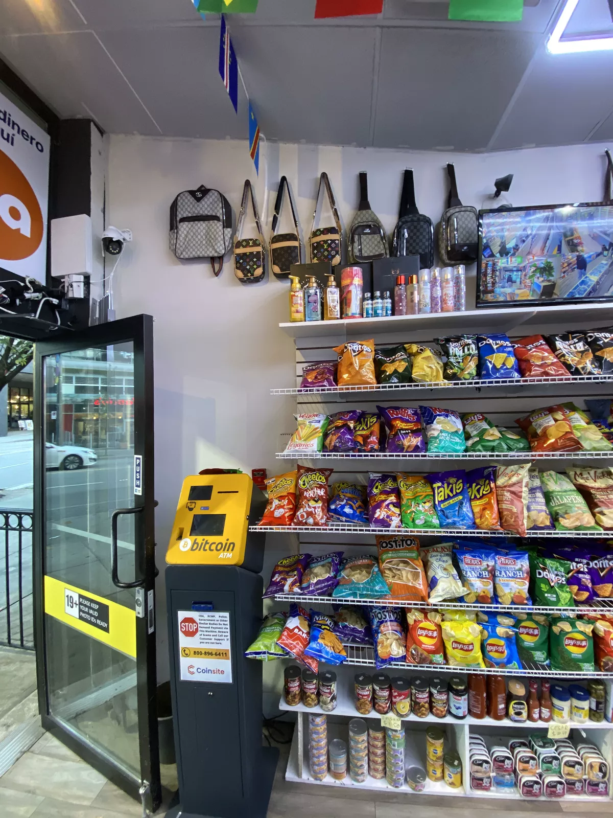 Just inside the door: the Bitcoin ATM beside the wall of imported chips