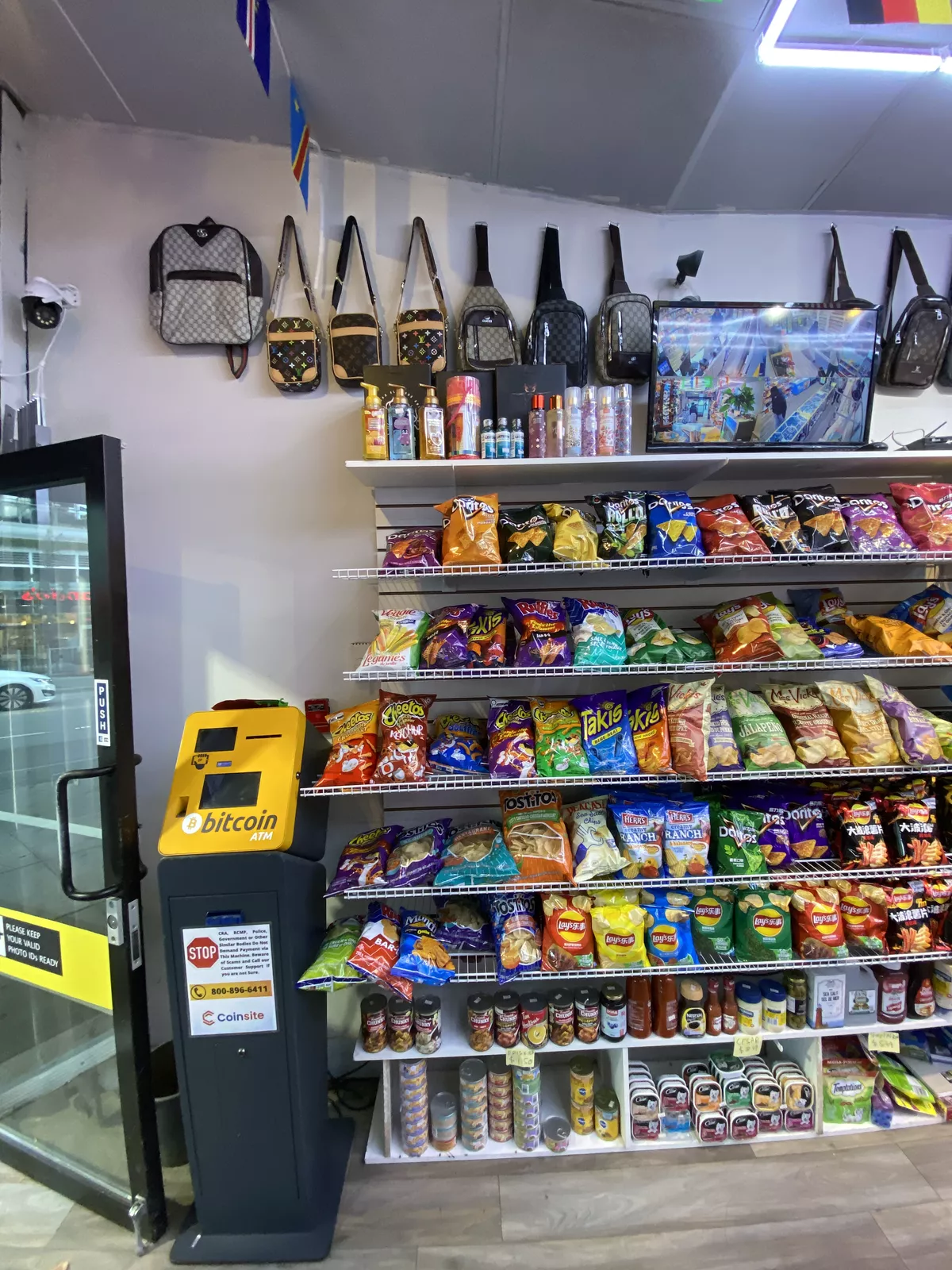 The wall of imported chips and candy by the door, beside the Bitcoin ATM